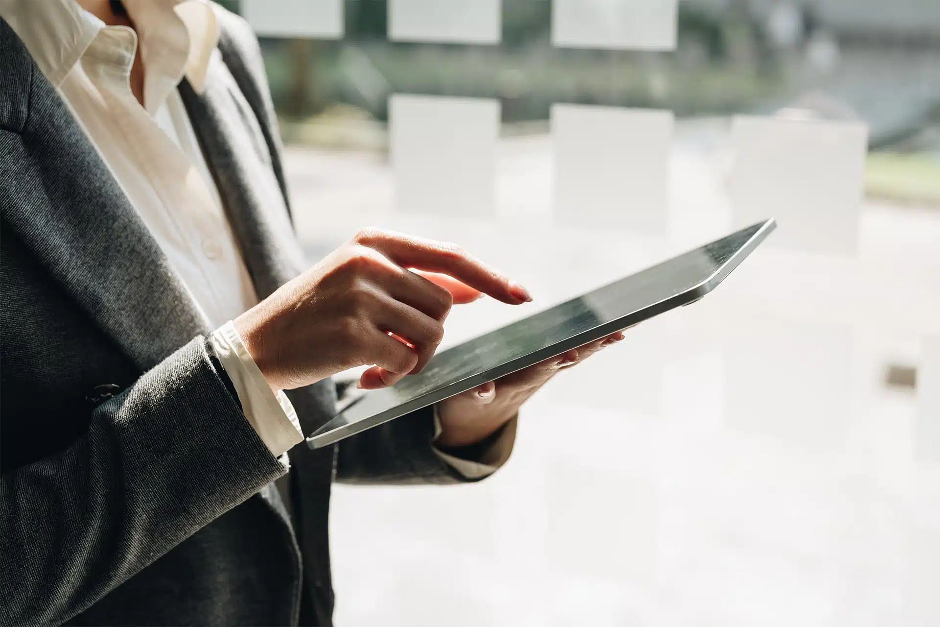 Close up of hands using a tablet to access a quality management system review